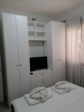 Namještena spavaća soba sa garderoberom, krevetom i televizorom. - image 7