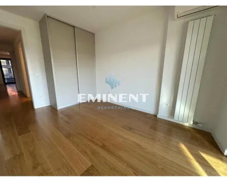 Empty bedroom with a built-in wardrobe and hardwood flooring. - image 9