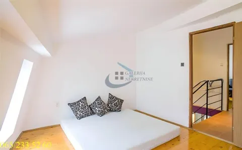 Attic space furnished as a bedroom with a floor bed. - image 8