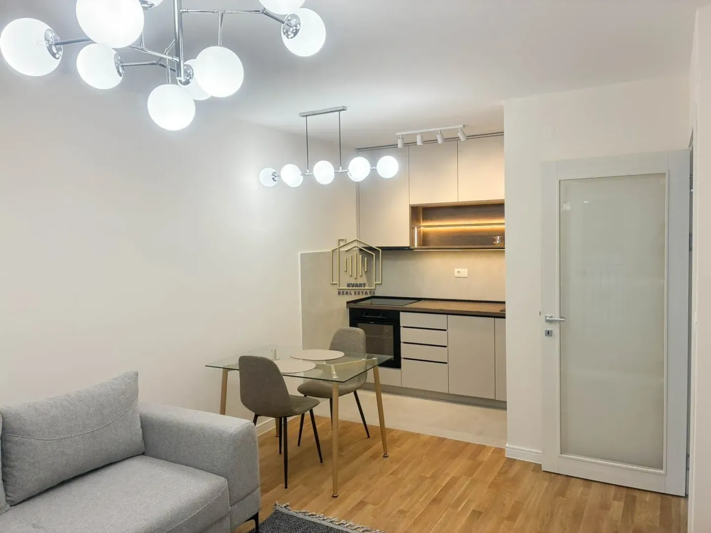 Living room with a dining area and kitchen in an open-plan layout.
