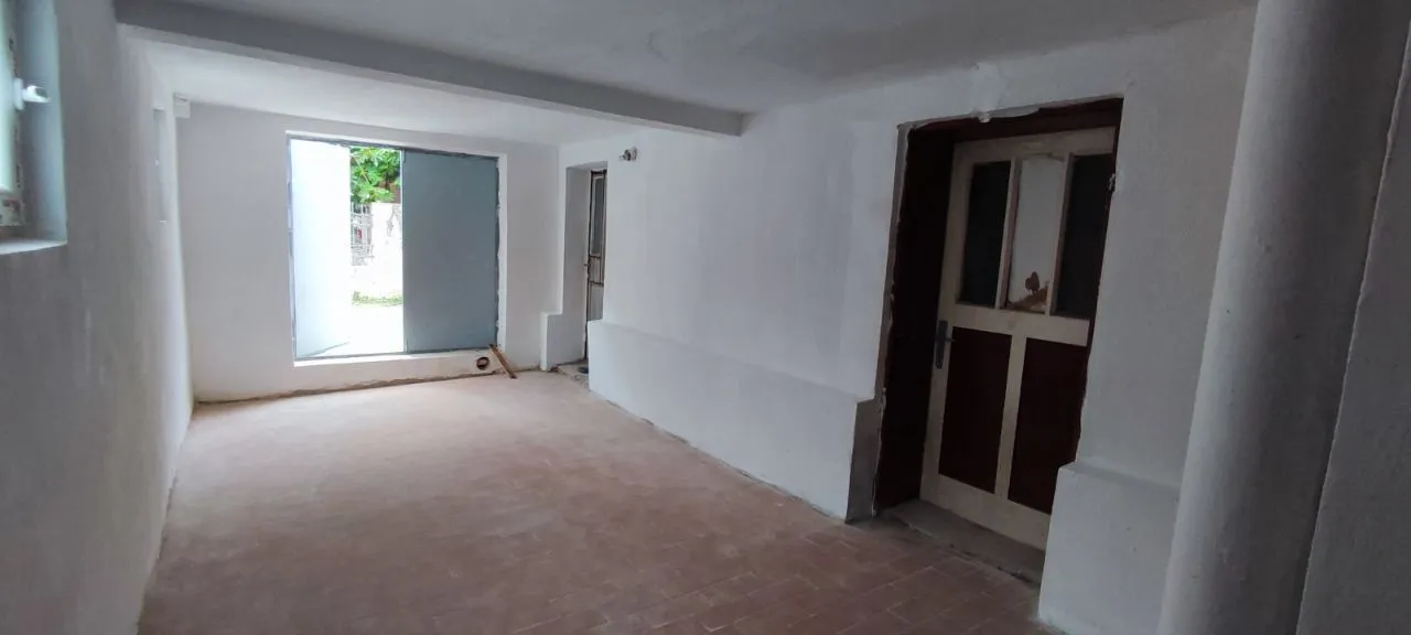 Empty room in a house under final renovation with a door and a window.