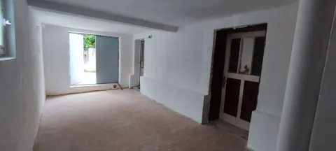 Empty room in a house under final renovation with a door and a window. - image 12