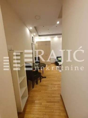 Living room with a dining area and parquet flooring.