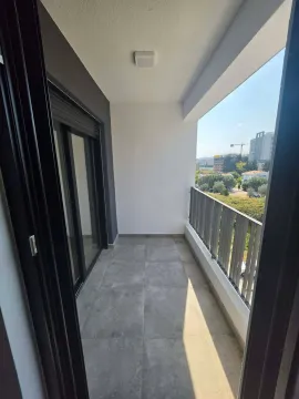 Empty covered balcony with tiled floor and view of the surroundings. - image 3