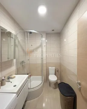 Compact bathroom with a shower cabin, washbasin, and toilet. - image 4