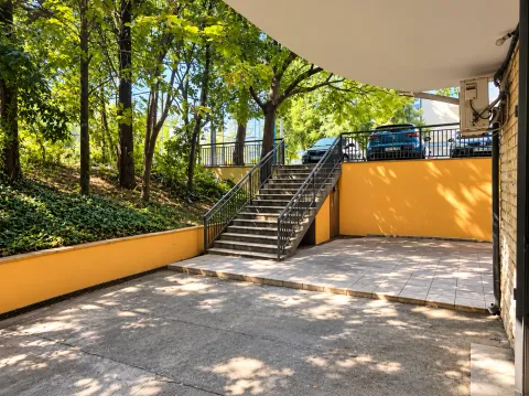View of the exterior part of the building with stairs and parking. - image 2