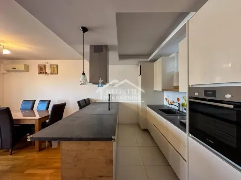 Modern kitchen with a bar counter and built-in appliances, connected to the dining area. - image 5