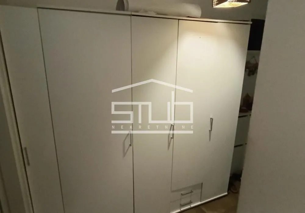 White wardrobe with doors and drawers in the bedroom.
