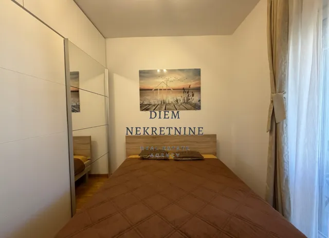 Furnished bedroom with a double bed and built-in wardrobe.