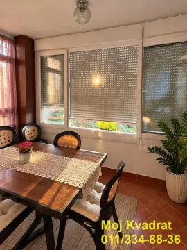Enclosed terrace with a dining table and chairs. - image 6