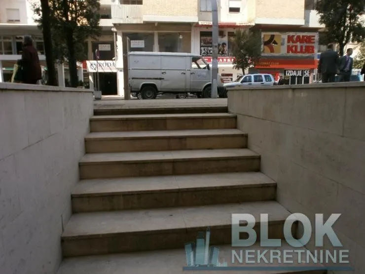 Entrance stairs with a view of the street and surrounding buildings.