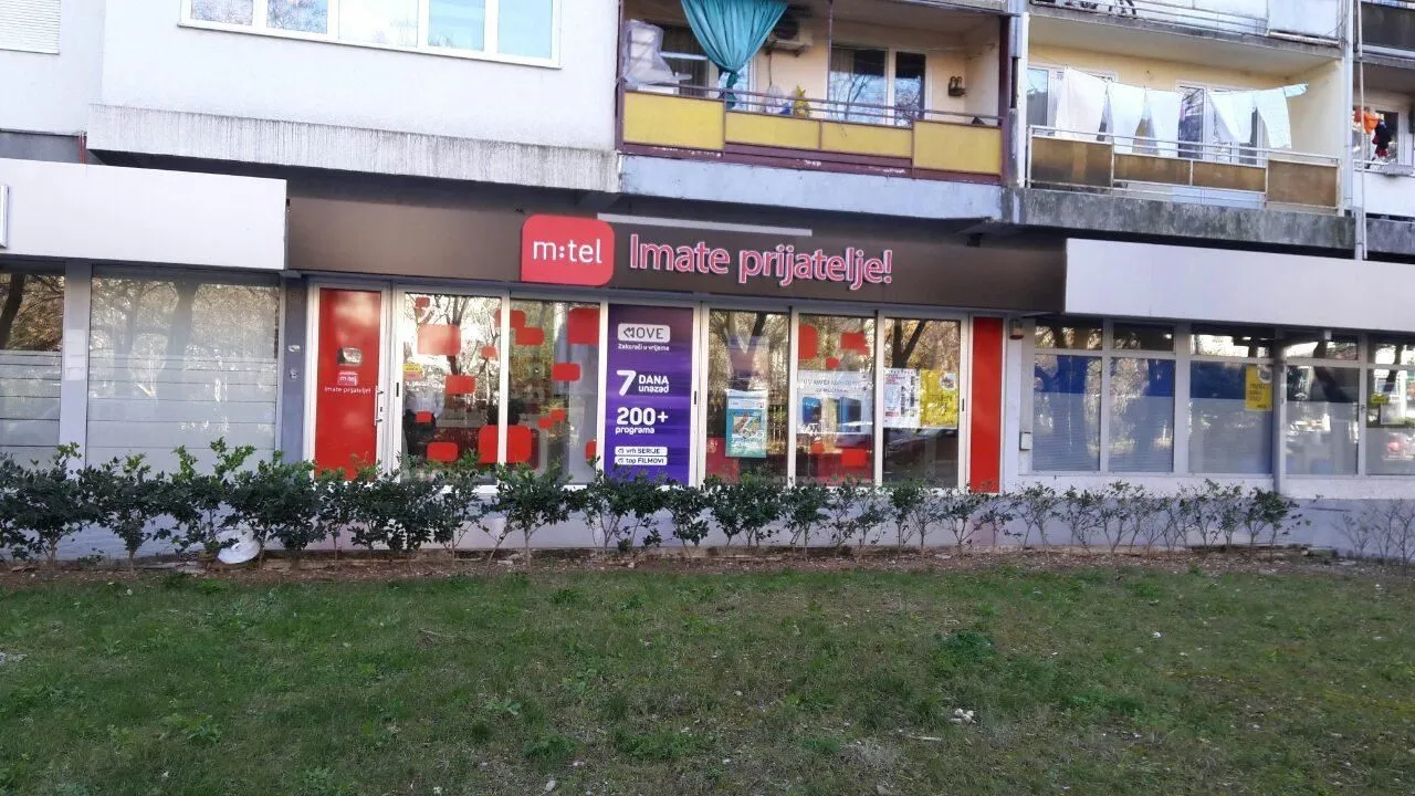 Shopfront and entrance of a commercial space on the ground floor of a building.
