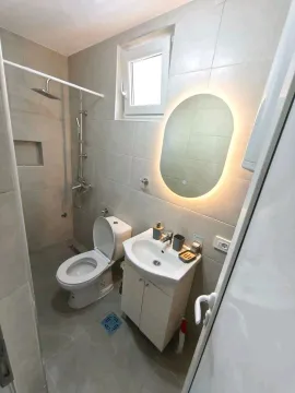 Manje opremljeno kupatilo sa tuš kabinom, umivaonikom i toaletom. - image 5