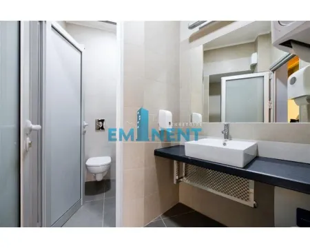 Modernly equipped bathroom with a washbasin, mirror, and toilet. - image 16