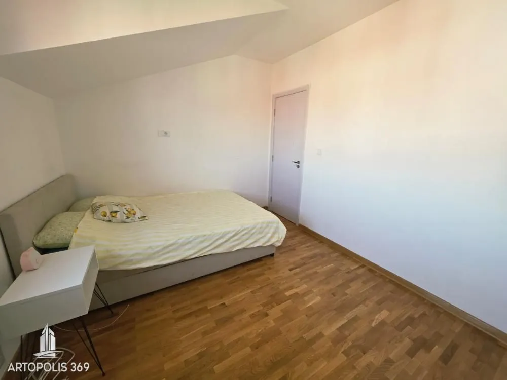 Smaller bedroom with a double bed and parquet flooring.