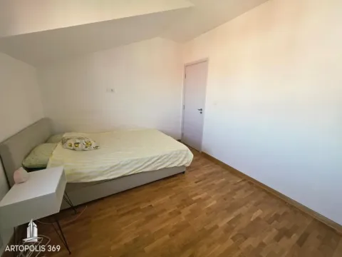 Smaller bedroom with a double bed and parquet flooring. - image 13
