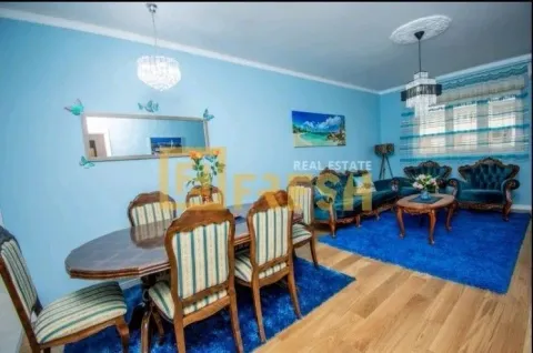 Spacious living room with a dining area in blue tones. - image 3