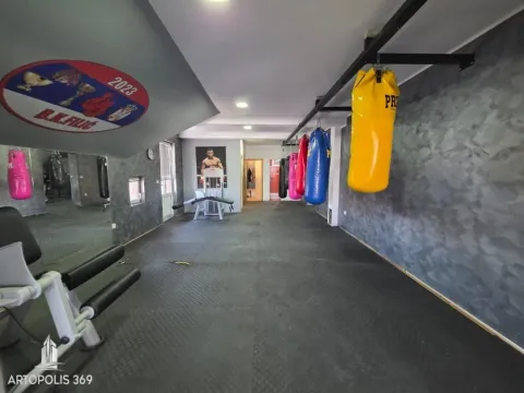 Interior of the gym with punching bags and exercise equipment. - image 4