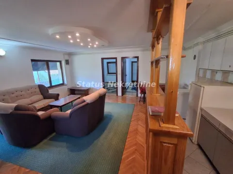 Living room with a seating set and an open-plan transition towards the kitchen area. - image 4
