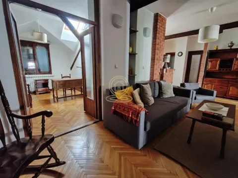 Living room with sofa and view of the adjacent room with a desk. - image 3
