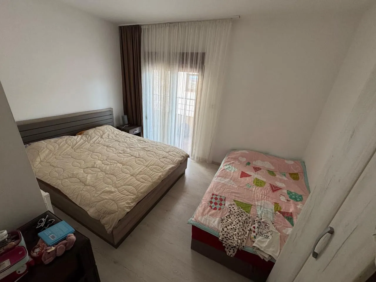 A bedroom with a double bed and a single bed.