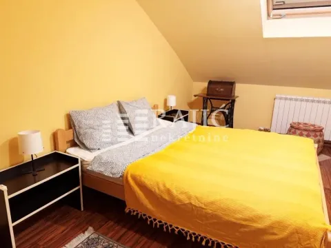 Attic bedroom with a bed and a yellow cover. - image 8
