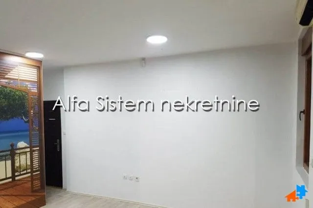 Empty room with white walls and recessed lighting.