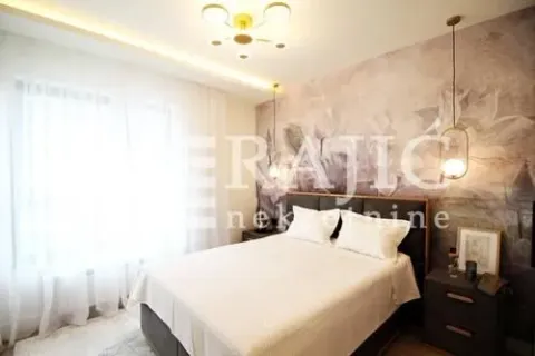 Modern bedroom with a double bed and decorative wallpaper. - image 8