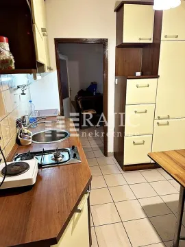 Smaller kitchen with wooden elements and a built-in sink. - image 4