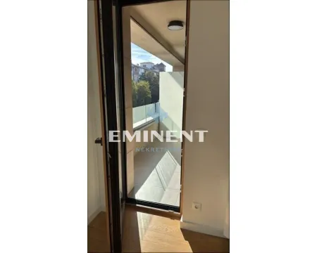 View through an open door to the balcony with a glass railing. - image 3