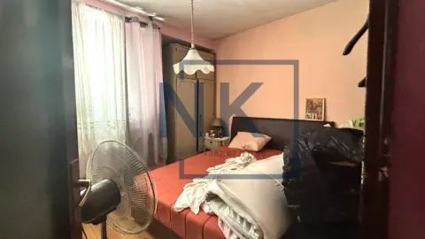 Bedroom with a bed, wardrobe, and a fan. - image 4