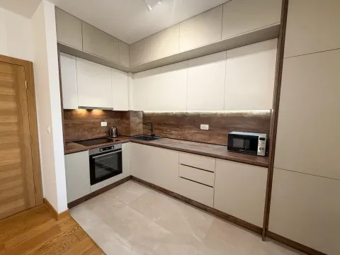 Modern kitchen with built-in appliances and wooden details. - image 2