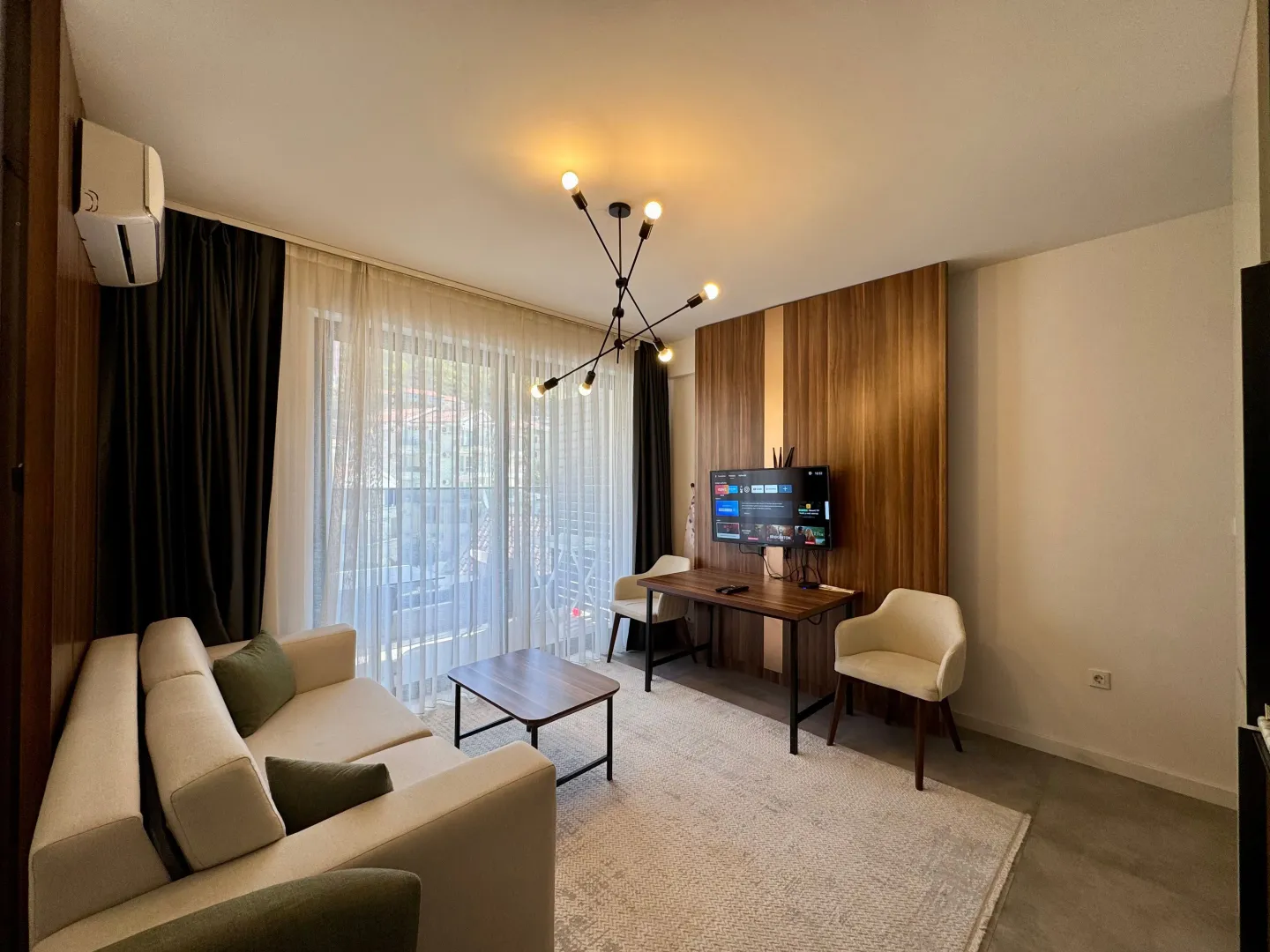 Living room with a sofa, desk, and TV.