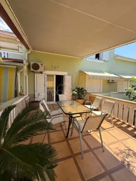 Spacious terrace with patio furniture and awning. - image 4
