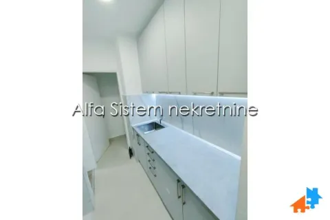 Small kitchen with white cabinets and a sink. - image 8