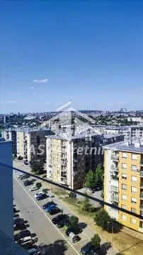 View from the terrace overlooking the urban neighborhood and a street with parking. - image 17