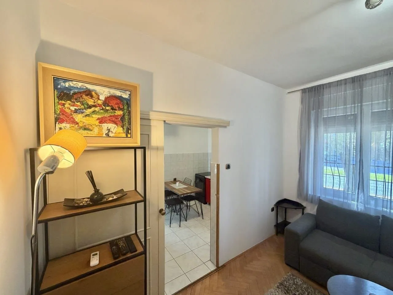 Living room with a sofa and a view of the kitchen.