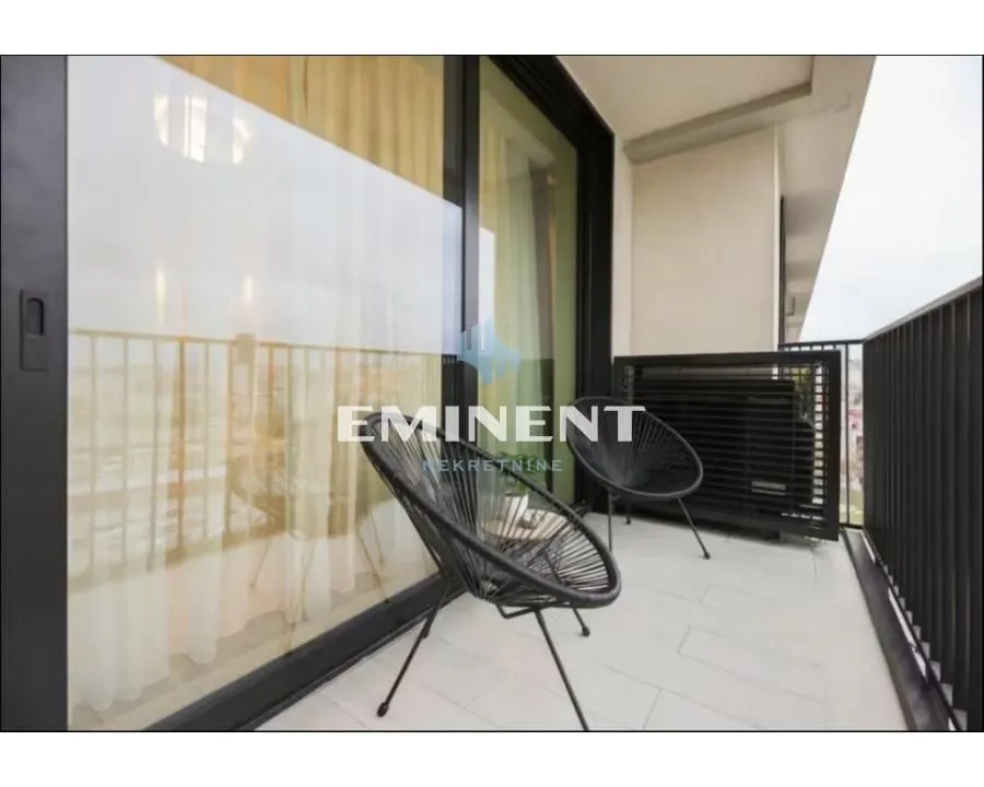 Furnished balcony with seating set and a view.