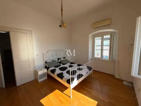 Bright bedroom with a double bed, wooden floor and a window. - image 6