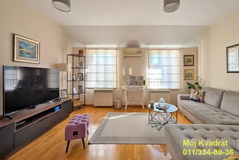Furnished living room with sofa set, TV, and wooden flooring. - image 20