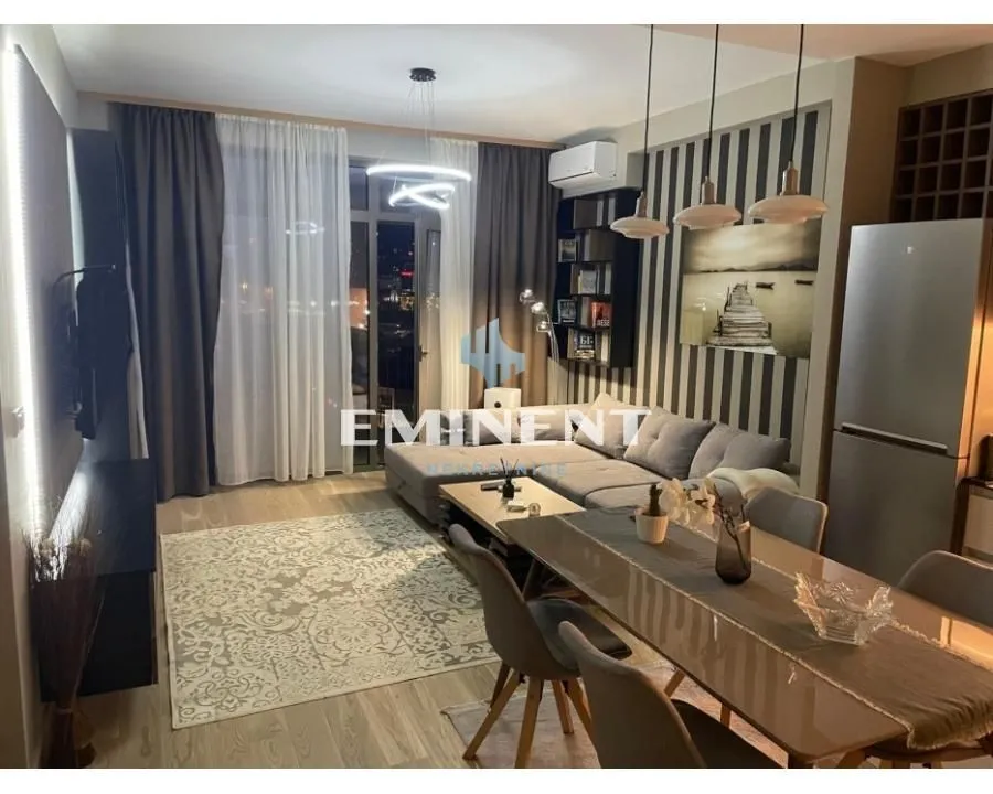 Living room with sofa set and dining area.