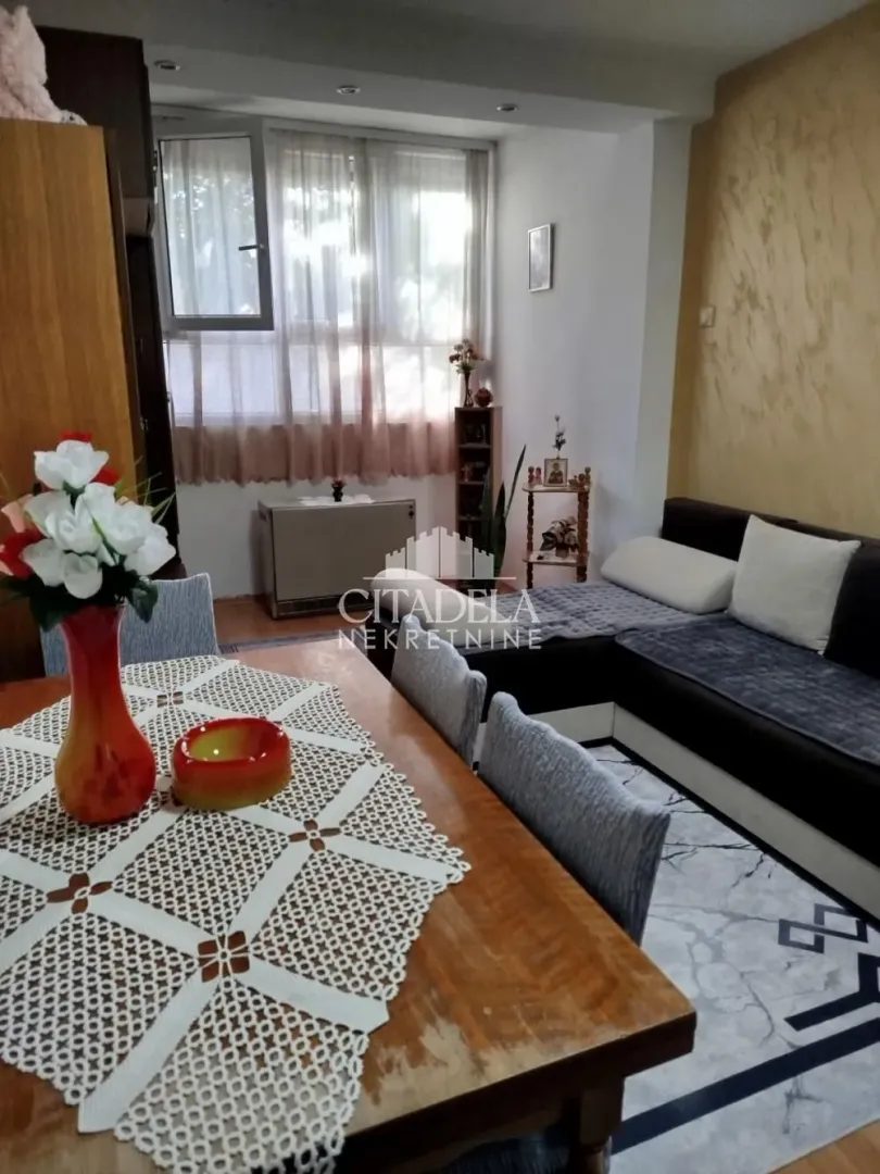 Living room with a sofa set and a dining table.