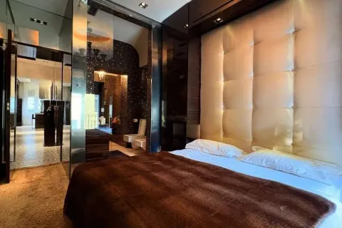 Modern bedroom with a large double bed and a padded headboard. - image 20