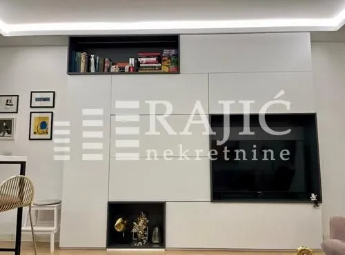 Living room with modern wall furniture and a TV.