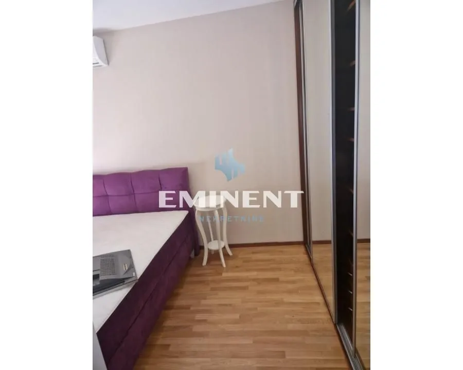 Bedroom with a bed and a fitted wardrobe with a mirror.