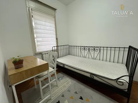 Smaller bedroom with a pull-out bed and a desk. - image 13