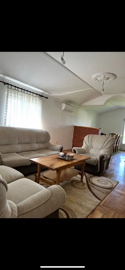 Living room with a seating set and a wooden coffee table.