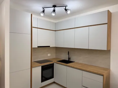 Modern kitchen with white cabinetry, wooden countertops, and built-in appliances. - image 11