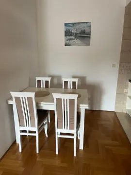 Dining area with a table and four chairs. - image 4