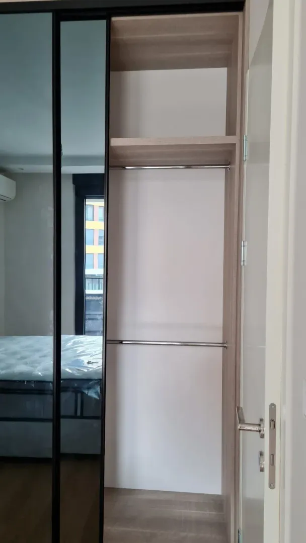 Built-in wardrobe with sliding doors and a mirror.